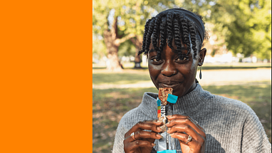 Mars Snacking logo alongside someone eating a KIND bar